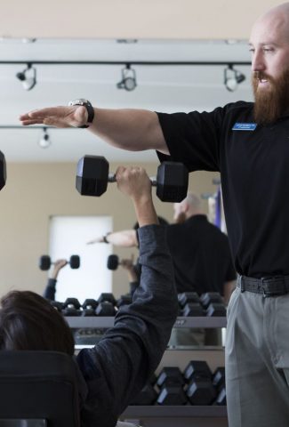 Physical therapist training expert Lucas demonstrates safe lifting to provide recovery from surgery and sports injury rehabilitation in Cody Wyoming