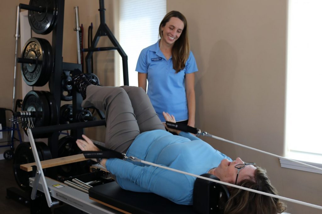 Guided core strengthening movements on the pilates reformer in Cody Wyoming