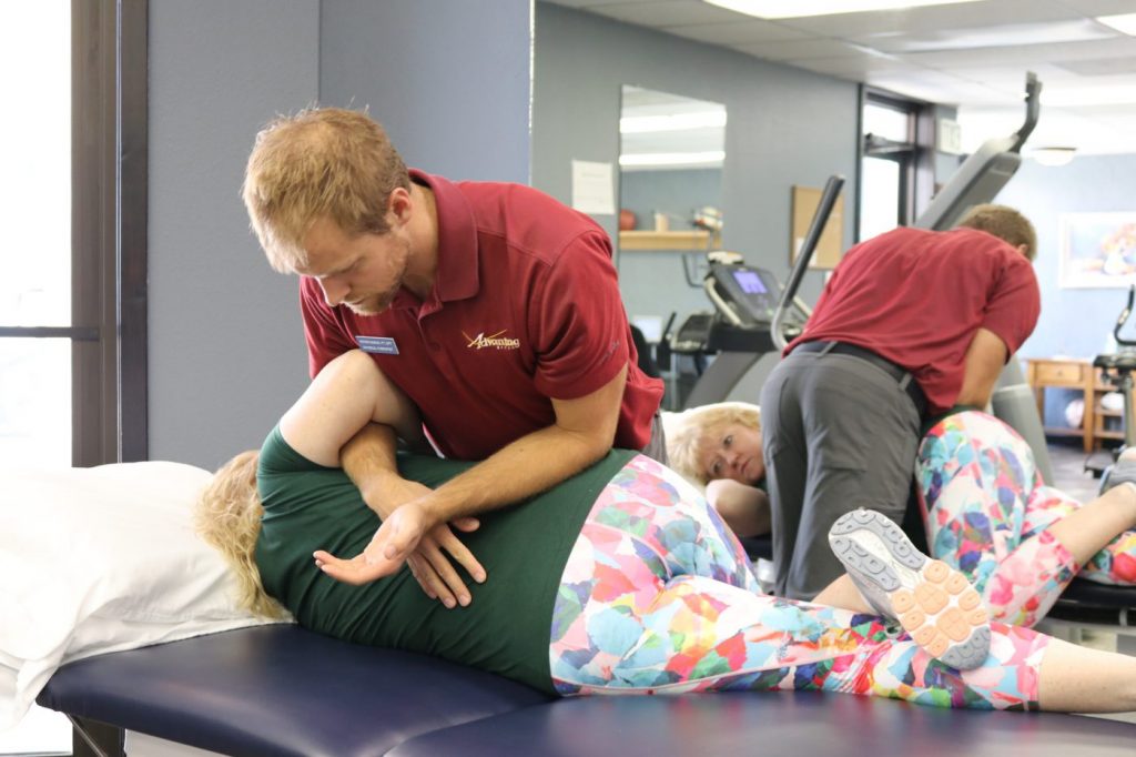 Powell Wyoming therapist appllying pressure to the patients back and hip to help ease pain in the targeted area